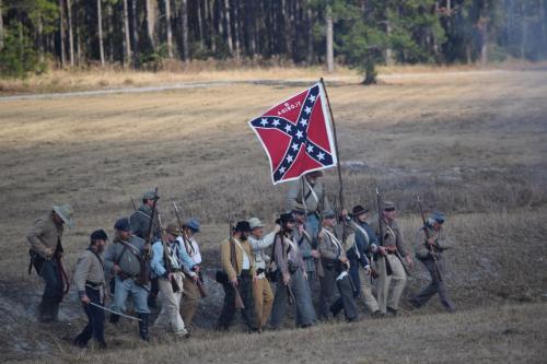 38th Brooksville Raid Civil War Re-enactment. Foot soldiers leaving the battlefield with their Confederate flag.