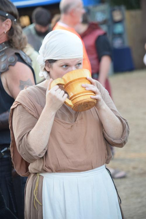 Sarasota Medieval Fair 2017. Peasant Medieval times drinking ale from her wooden stein.